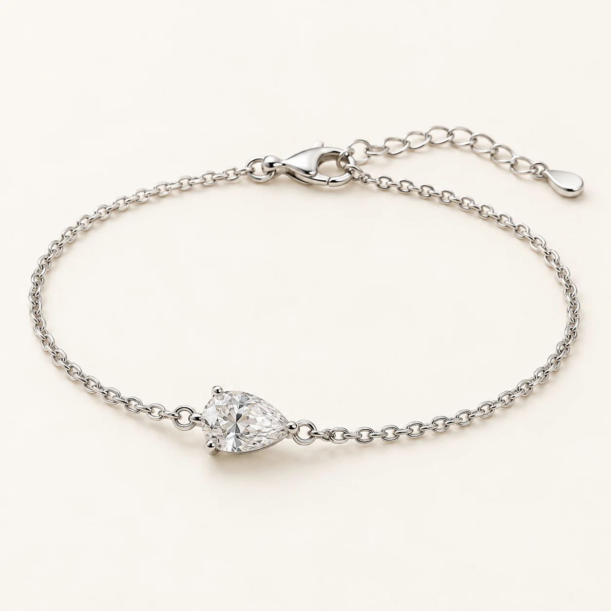 Serenne Pear in Silver, fine chain bracelet, single clear pear shaped cubic zirconia central motif, lobster clasp with extender